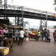 Muslims offer free food to passers-by on the occasion of Muharram—one of four sacred months in Islamic calendar. Above them, an open-air conveyor belt carries coal to the Hasdeo Thermal Power Station in Darri near Korba.
